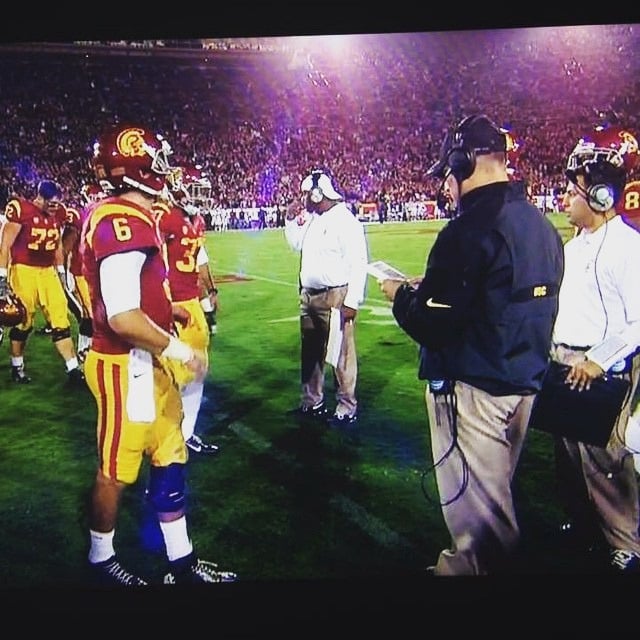 Coach Bass working with a quarterback on throwing mechanics during a private training session